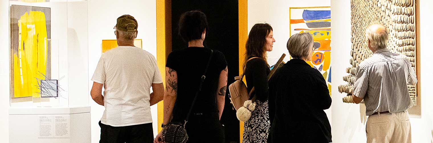 a group of visitors admiring modern art pieces