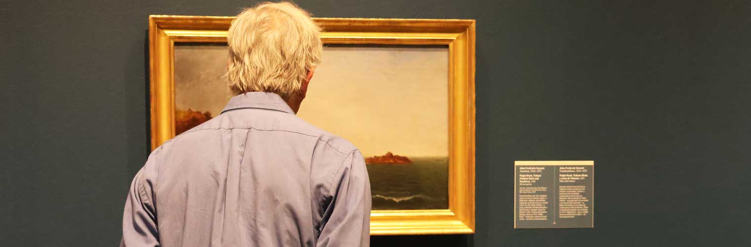 back of an older man looking at a landscape classic painting