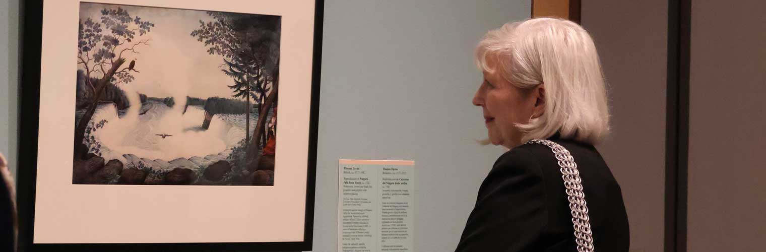 woman looking at a print with a smile on her face