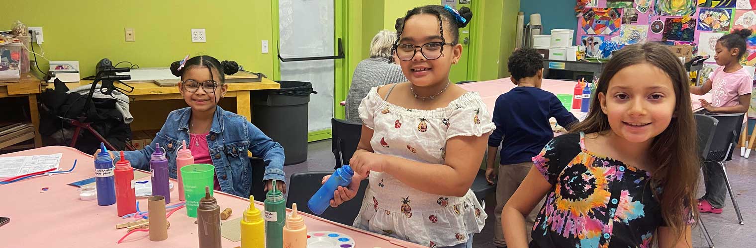 young girls at a craft event painting