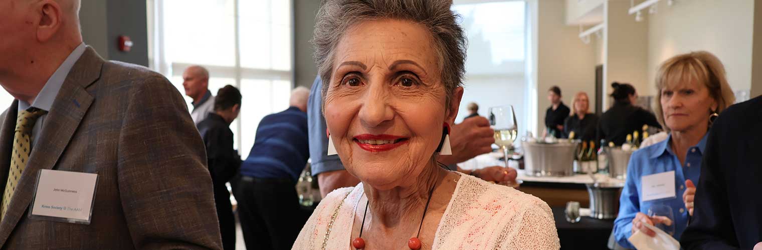 a woman smiling at an event