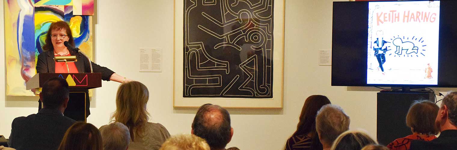 speaker talking to an audience about Keith Haring Art
