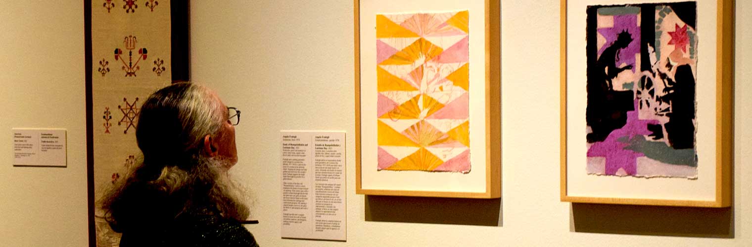 woman viewing a mixed media art pieces